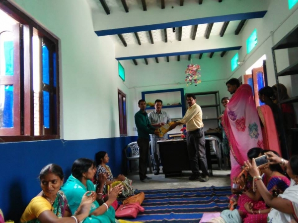 Block Project Manager, SVEP handing over the first lot of school uniforms stitched by entrepreneurs in Bihar